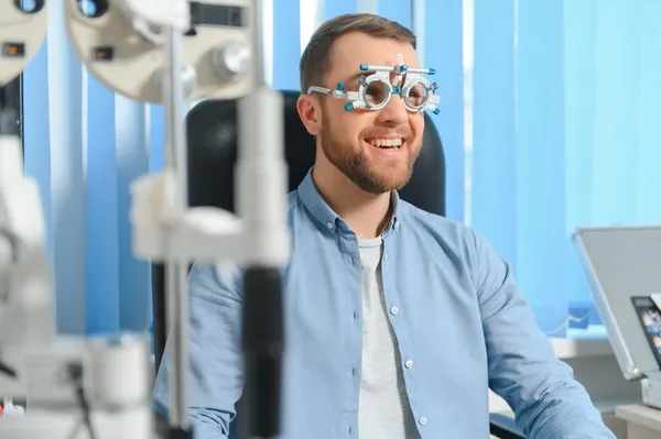 Patient undergoing a vision evaluation at a clinic with an ophthalmologist in Mexico, using specialized equipment for accurate diagnosis.